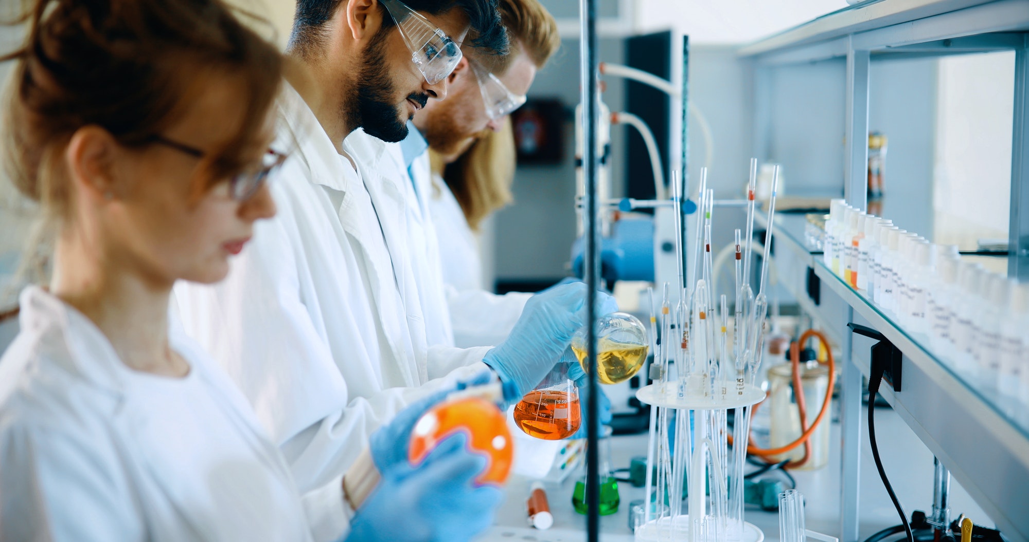 Young students of chemistry working in laboratory